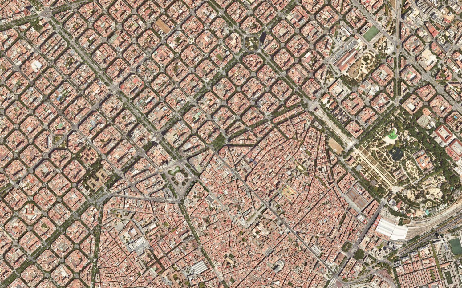 Barcelona from directly above. The upper left is a regular grid of octagonal blocks, the Eixample. The lower centre and right is a dense, irregular tangle of streets, the old town, with the Ciutadella park at the right.